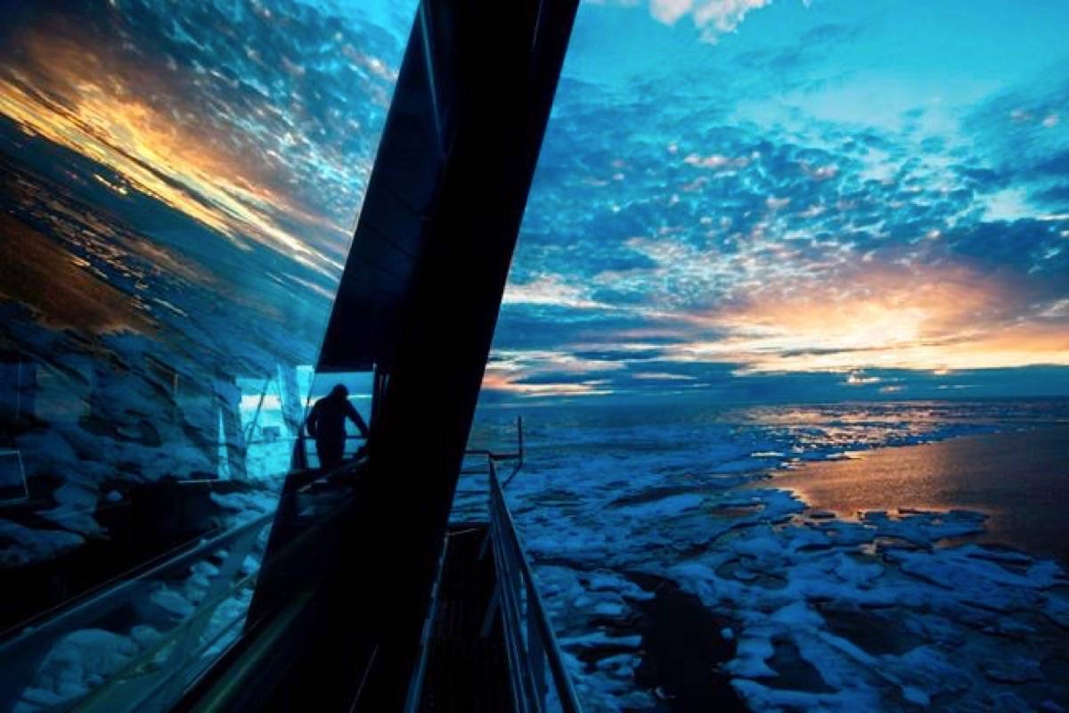 Nigel Greenwood, assistant ice navigator, looks out at the ice from the bridge while standing watch overnight aboard the Finnish icebreaker MSV Nordica as it traverses the Northwest Passage in the Canadian Arctic Archipelago on July 21, 2017. (David Goldman/The Canadian Press/AP)
