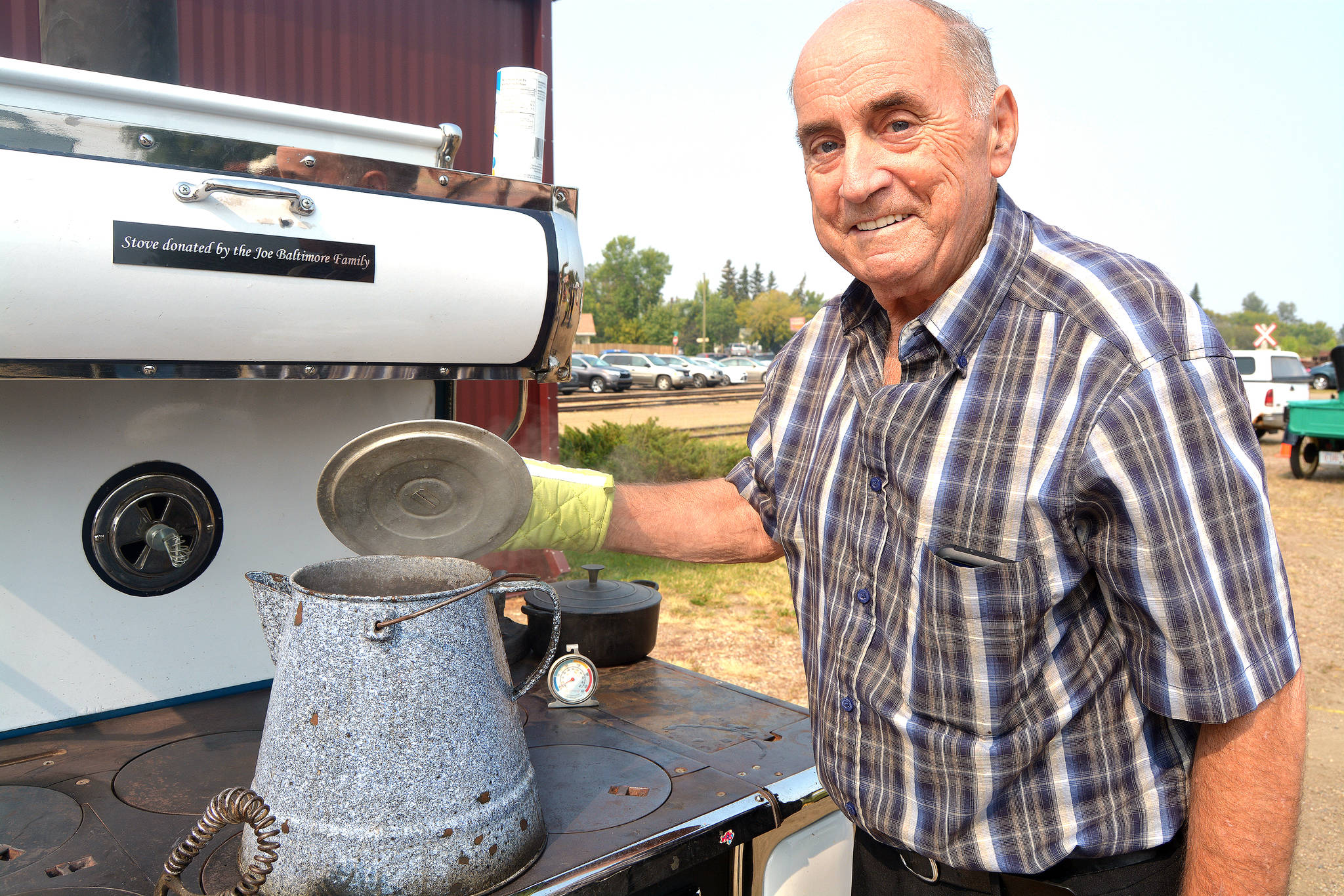 Coffee is on! Jim Stroud of drumheller brews a big pot of coffee on a wood stove during Stettler P & H Elevator Preservation Society’s annual fall supper Aug. 25. The stove was donated to the society by the Joe Baltimore family of Stettler. (Lisa Joy/Black Press)