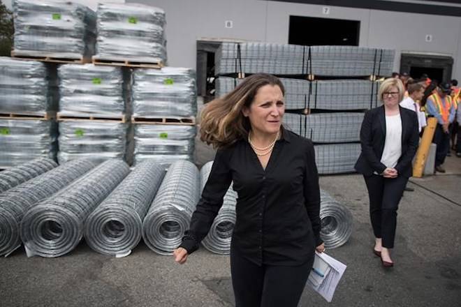 Minister of Foreign Affairs Chrystia Freeland, front, leaves a news conference after touring Tree Island Steel, in Richmond, B.C., on Friday, August 24, 2018. THE CANADIAN PRESS/Darryl Dyck