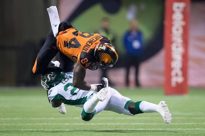 B.C. Lions’ Emmanuel Arceneaux (84) is upended by Saskatchewan Roughriders’ Matt Elam after making a reception during the first half of a CFL football game in Vancouver, on Saturday August 25, 2018. THE CANADIAN PRESS/Darryl Dyck