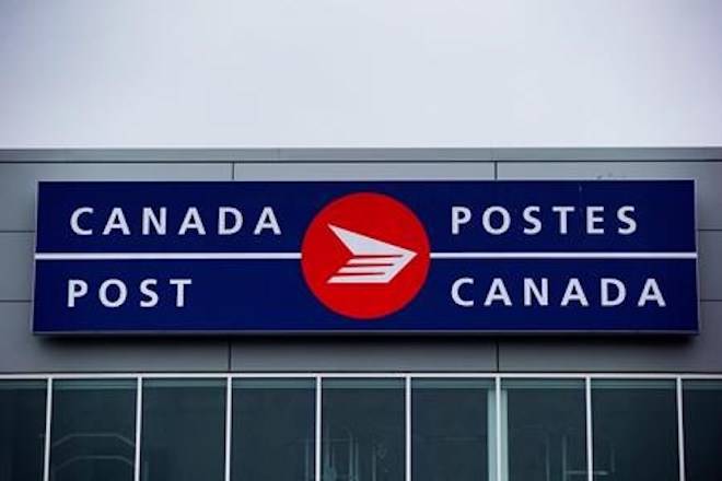The Canada Post logo is seen on the outside the company’s Pacific Processing Centre, in Richmond, B.C., on June 1, 2017. Canada’s postal service is reporting a loss of nearly a quarter billion dollars in the second quarter of this year - and directly linking it to what it expects will be a massive payout to resolve a pay equity dispute with its biggest union. THE CANADIAN PRESS/Darryl Dyck