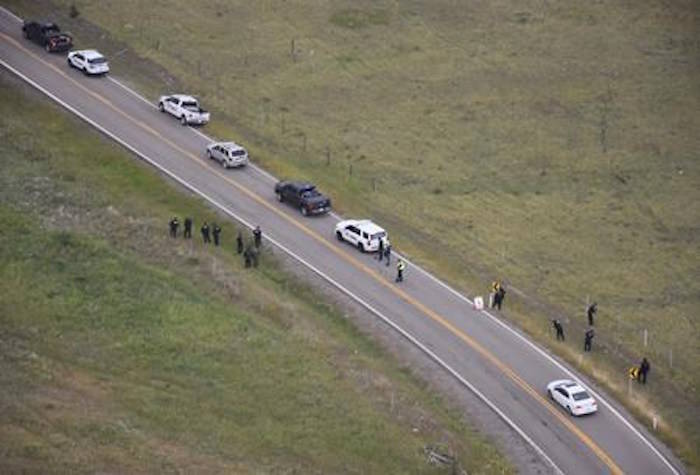 Police investigate the scene of a shooting along Highway 1A near Morley, Alta., in this August 2018 police handout photo. A 16-year-old youth has been charged with a highway shooting in southern Alberta that left a German tourist with a serious brain injury. RCMP say the youth, who is from Stoney Nakoda First Nation but he can’t be named, is facing 14 criminal charges, including attempted murder. THE CANADIAN PRESS/HO - RCMP