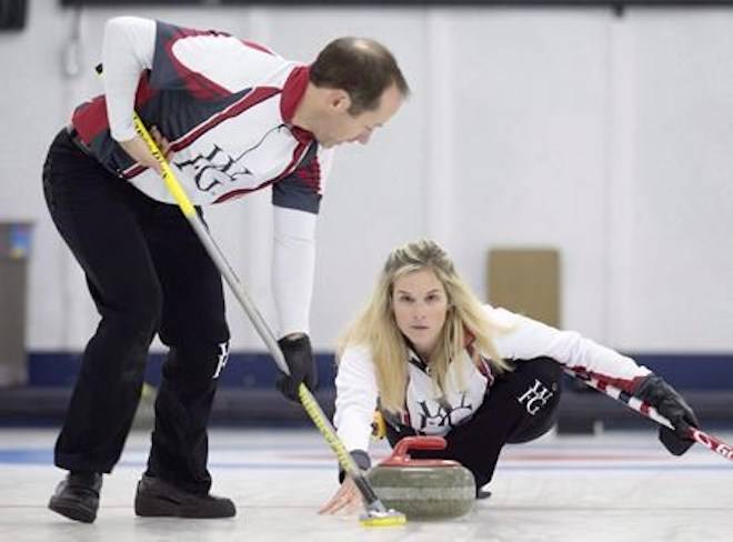 Brent Laing sweeps for teammate Jennifer Jones in the Wall Grain Mixed Doubles Curling Classic at the Oshawa Curling Club in Oshawa, Ont. on Monday, November 16, 2015. THE CANADIAN PRESS/Frank Gunn
