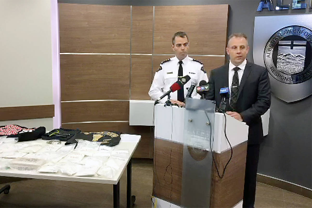 RCMP Chief Supt. Ian Lawson, left, stands with ALERT CEO Chad Coles as the pair speak to media about the conclusion of a significant year long organized crime investigation, resulting in the seizure of cocaine and 10 people facing more than 40 charges. Image: Live feed screenshot