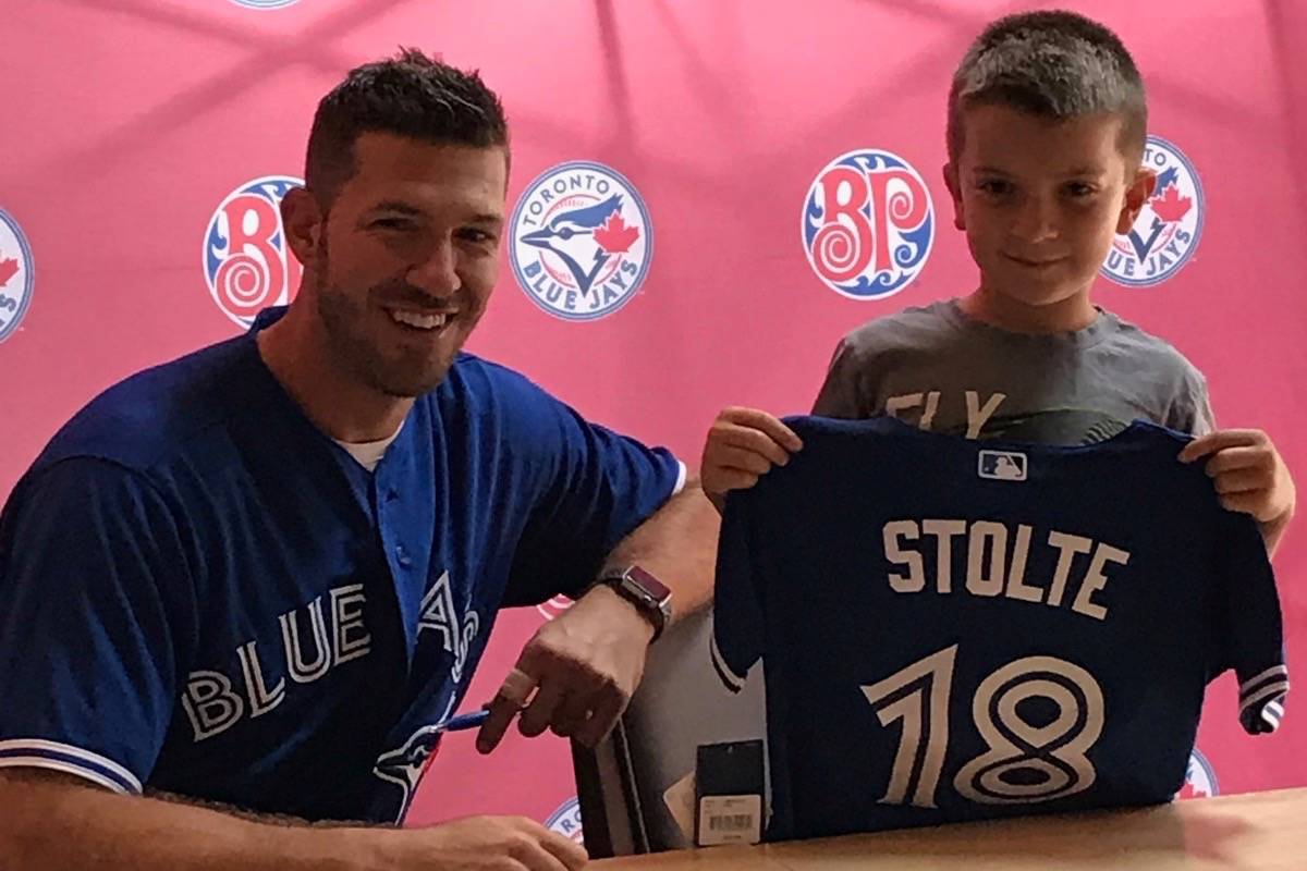 Blackfalds resident Jonathan Stolte was able to sign a one-day contract with former Blue Jay J.P. Arenciba after he won a contest through the Lacombe Boston Pizza. Photo Submitted