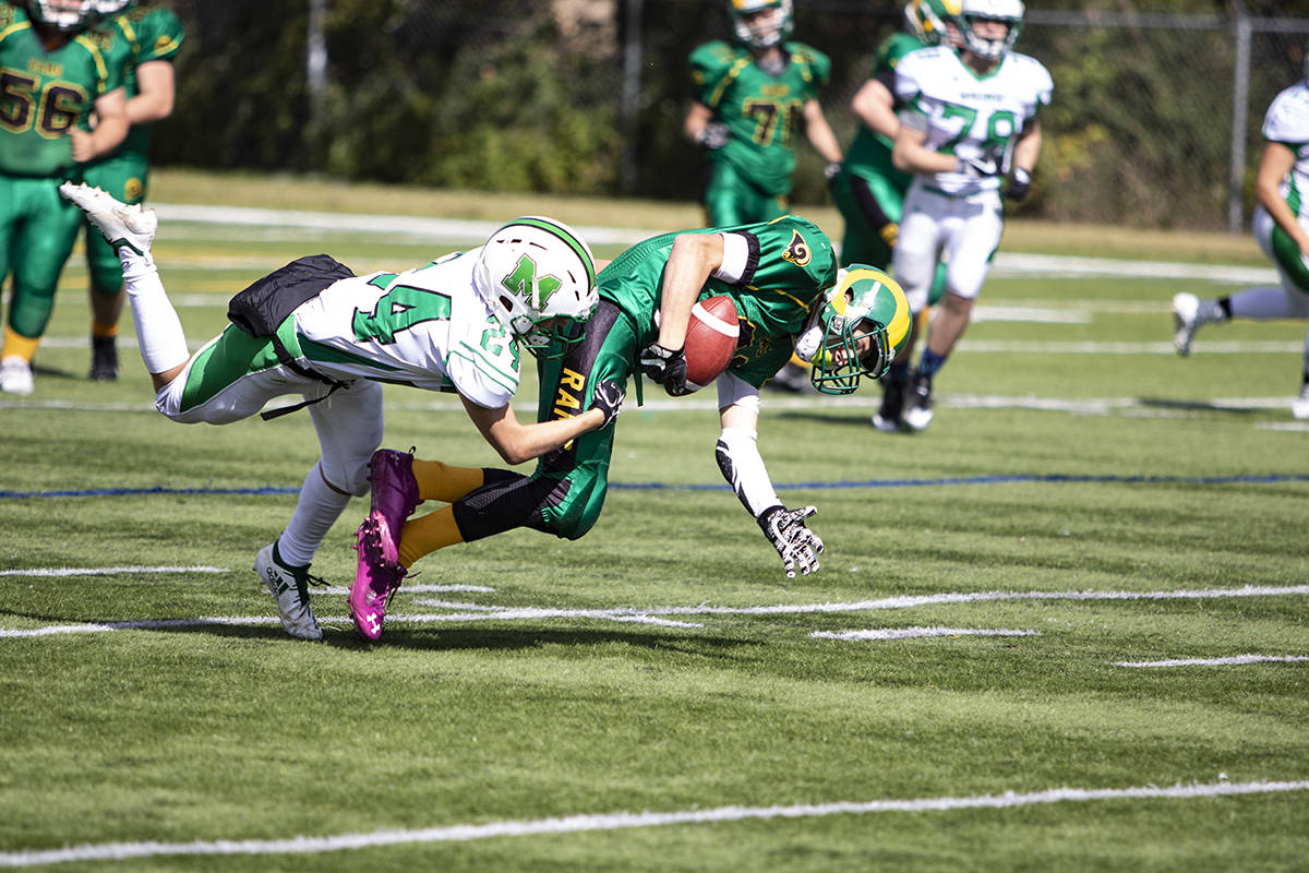 Lacombe Ram Runningback Zach Schwab was taken down by Medicine Hat Mohawk Ethon Scott in the Rams exhibition opener to their 2018 season. Todd Colin Vaughan/Lacombe Express