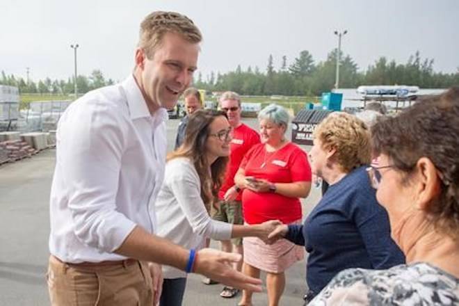 New Brunswick Liberal Leader Brian Gallant and wife Karine Lavoie are greeted by supporters after arriving at a campaign stop in Oromocto, N.B., on September 1, 2018. THE CANADIAN PRESS/James West