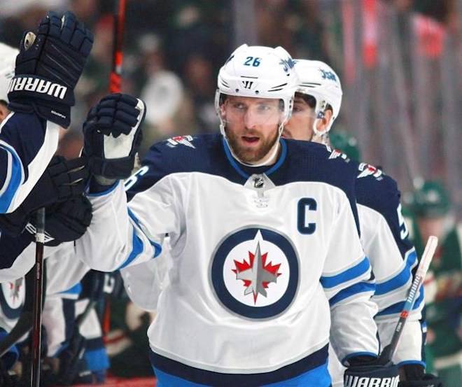 Winnipeg Jets forward Blake Wheeler (26) is congratulated after scoring a goal against the Minnesota Wild in the first period of an NHL hockey game on Sunday, April 15, 2018, in St. Paul, Minn. THE CANADIAN PRESS/AP, Andy Clayton-King
