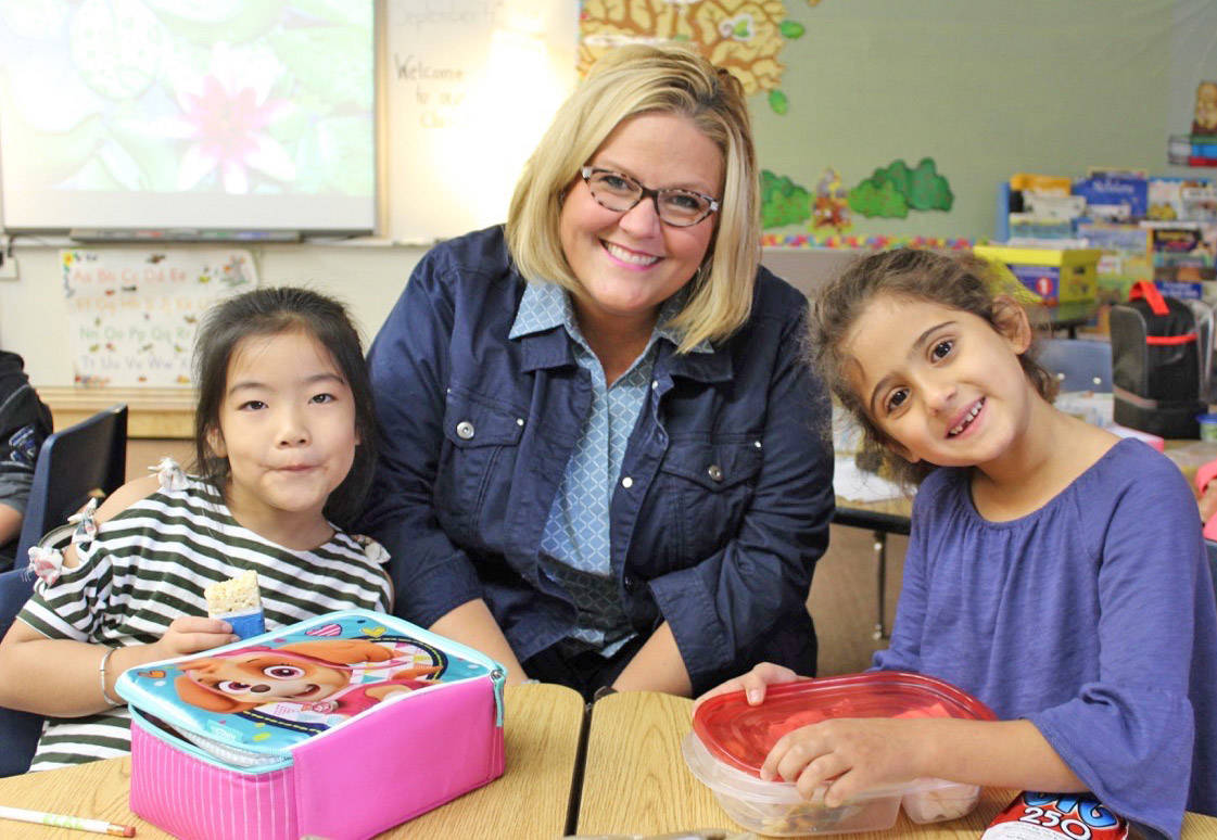 Maya Smaisem, left, enjoys her snack time with Principal Kim Walker and Katherine Mu on the first day back to school at Fairview Elementary. Carlie Connolly/Red Deer Express