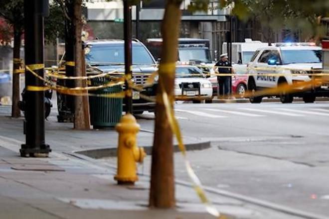 An area is cordoned off with police tape as emergency personnel and police respond to reports of an active shooter situation near Fountain Square, Thursday, Sept. 6, 2018, in downtown Cincinnati. (AP Photo/John Minchillo)