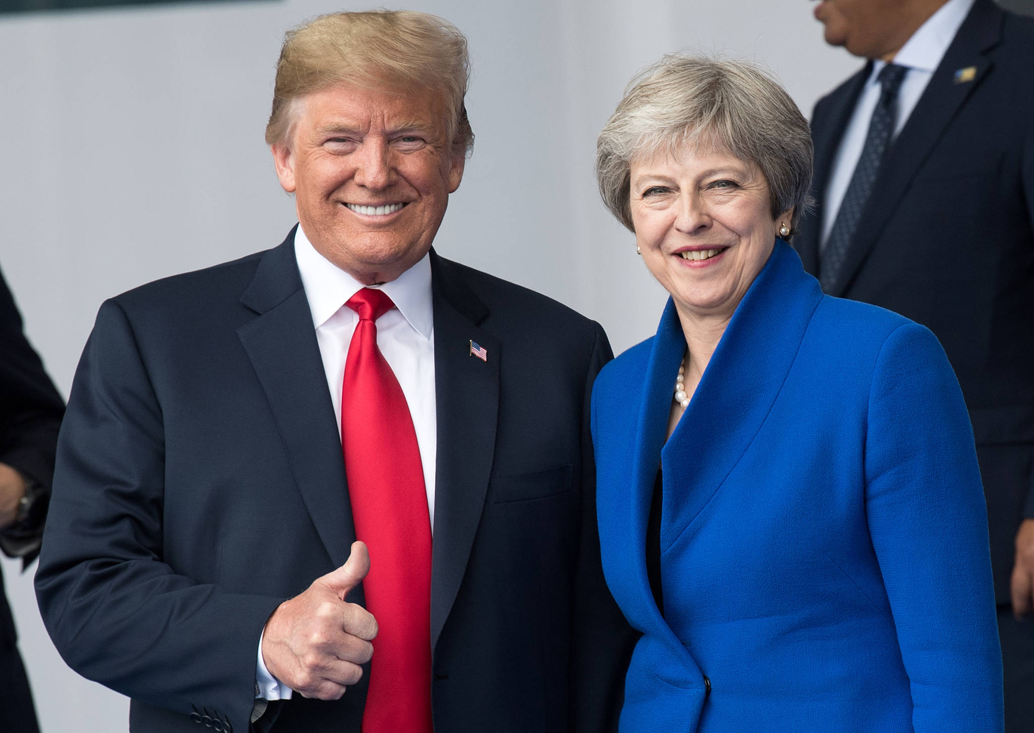 Theresa May, right,, Prime Minister of the United Kingdom, and Donald Trump, President of the United States of America, stand next to each other during a photocall at the NATO Summit on July 11, 2018 in Brussels, Belgium. (Bernd von Jutrczenka/DPA/Abaca Press/TNS)