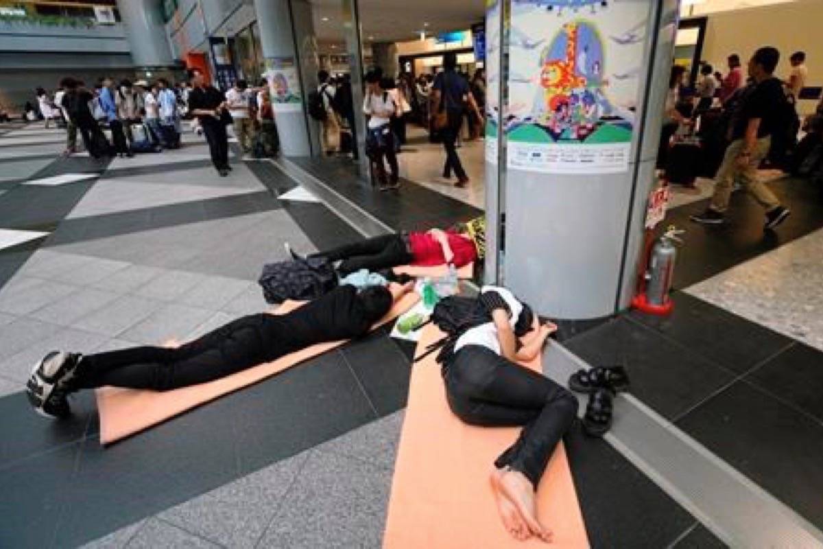 Stranded passengers wait for their flights at Chitose airport in Chitose, Hokkaido, northern Japan, Saturday, Sept. 8, 2018. The regional airport was beginning to resume operations after hundreds of flights had been cancelled, stranding thousands of travelers, due to Thursday’s power outage and light quake damage. (AP Photo/Eugene Hoshiko)