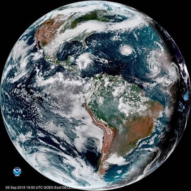 This enhanced satellite image provided by NOAA shows Hurricane Florence, third from right, in the Atlantic Ocean on Sunday, Sept. 9, 2018. At right is Tropical Storm Helene, and second from right is Tropical Storm Isaac. (NOAA via AP)