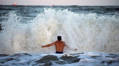 Body surfer Andrew Vanotteren, of Savannah, Ga., crashes into waves from Hurricane Florence, Wednesday, Sept., 12, 2018, on the south beach of Tybee Island, Ga. (AP Photo/Stephen B. Morton)