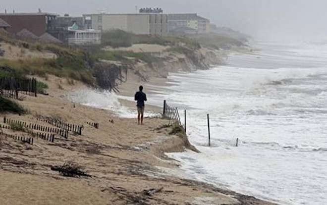 Heavy surf crashes the dunes at high tide in Nags Head, N.C., Thursday, Sept. 13, 2018 as Hurricane Florence approaches the east coast. (AP Photo/Gerry Broome)