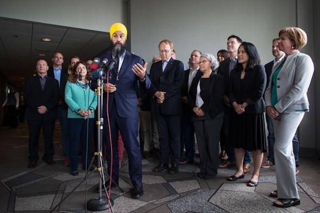 NDP Leader Jagmeet Singh, front left, is flanked by NDP MPs as he responds to questions after a three-day NDP caucus national strategy session in Surrey, B.C., on Thursday September 13, 2018. THE CANADIAN PRESS/Darryl Dyck