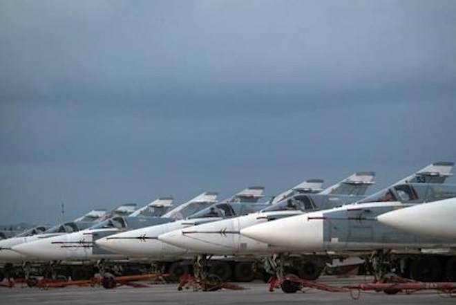 FILE- In this file photo dated Friday, March 4, 2016, Russian warplanes are parked at Hemeimeem air base in Syria. (AP Photo/Pavel Golovkin, FILE)