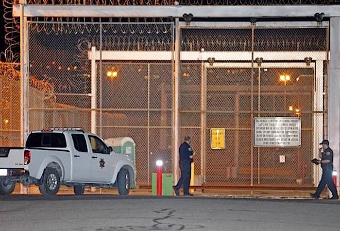 Correctional officers stand outside a gate at the Utah State Correctional Facility Wednesday, Sept. 19, 2018, in Draper, Utah. (AP Photo/Rick Bowmer)