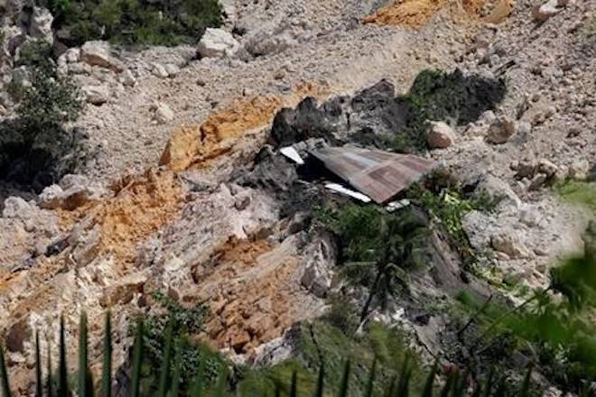 A destroyed house that was swept more than a mile downhill following a massive landslide is seen in Naga, central Philippines Friday, Sept. 21, 2018. Philippine troops and police forcibly evacuated residents of five villages vulnerable to landslides after the collapse of a mountainside buried dozens of homes.(AP Photo/Bullit Marquez)