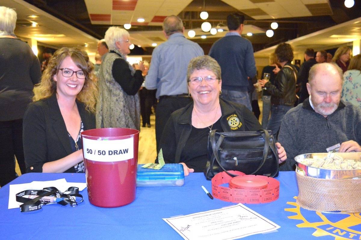 Stacey Benjamain from the Stettler Board of Trade, left, and Fran Snowden of Stettler Rotary Club sell tickets at Taste of Stettler, while Eric Snowden counts money. The 200 available tickets sold out fast for the annual Rotary Taste of Stettler event held at the Hub on Sept. 21. (Lisa Joy/Stettler Independent)