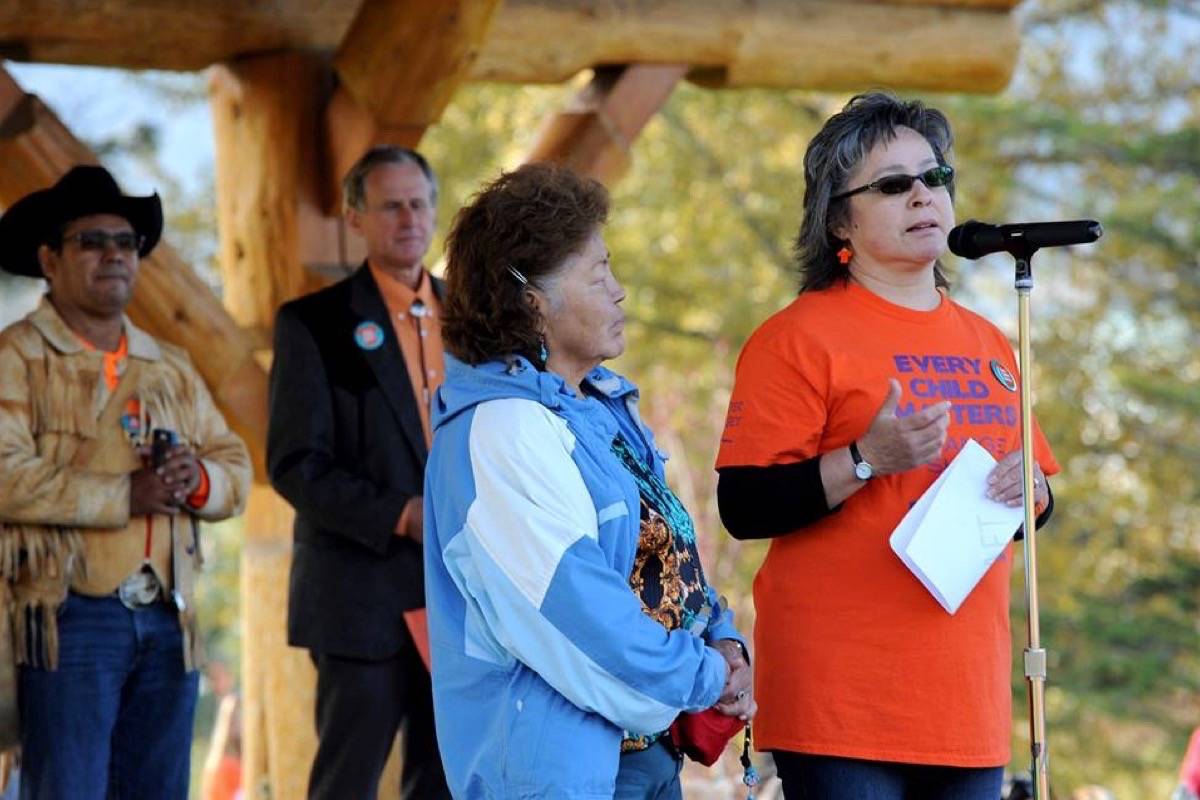 Tribune file photo                                Phyllis Webstad (right), who wore the original orange shirt, speaks at a Boitanio Park on Orange Shirt Day.