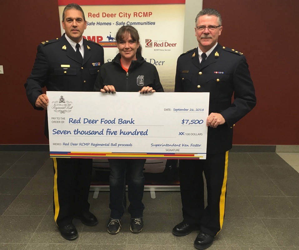 From left, Red Deer RCMP Insp. Dean LaGrange and Supt. Ken Foster presented Sheila Wetherelt of the Red Deer Food Bank with $7,500 on Sept. 28th. The funds come from $15,000 raised during the annual Regimental Ball held last month. Red Deer Victim Services also received $7,500 from the proceeds raised.                                Mark Weber/Red Deer Express