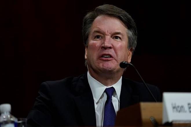 Senator confronted by angry protester, calls for delay on key Kavanaugh vote