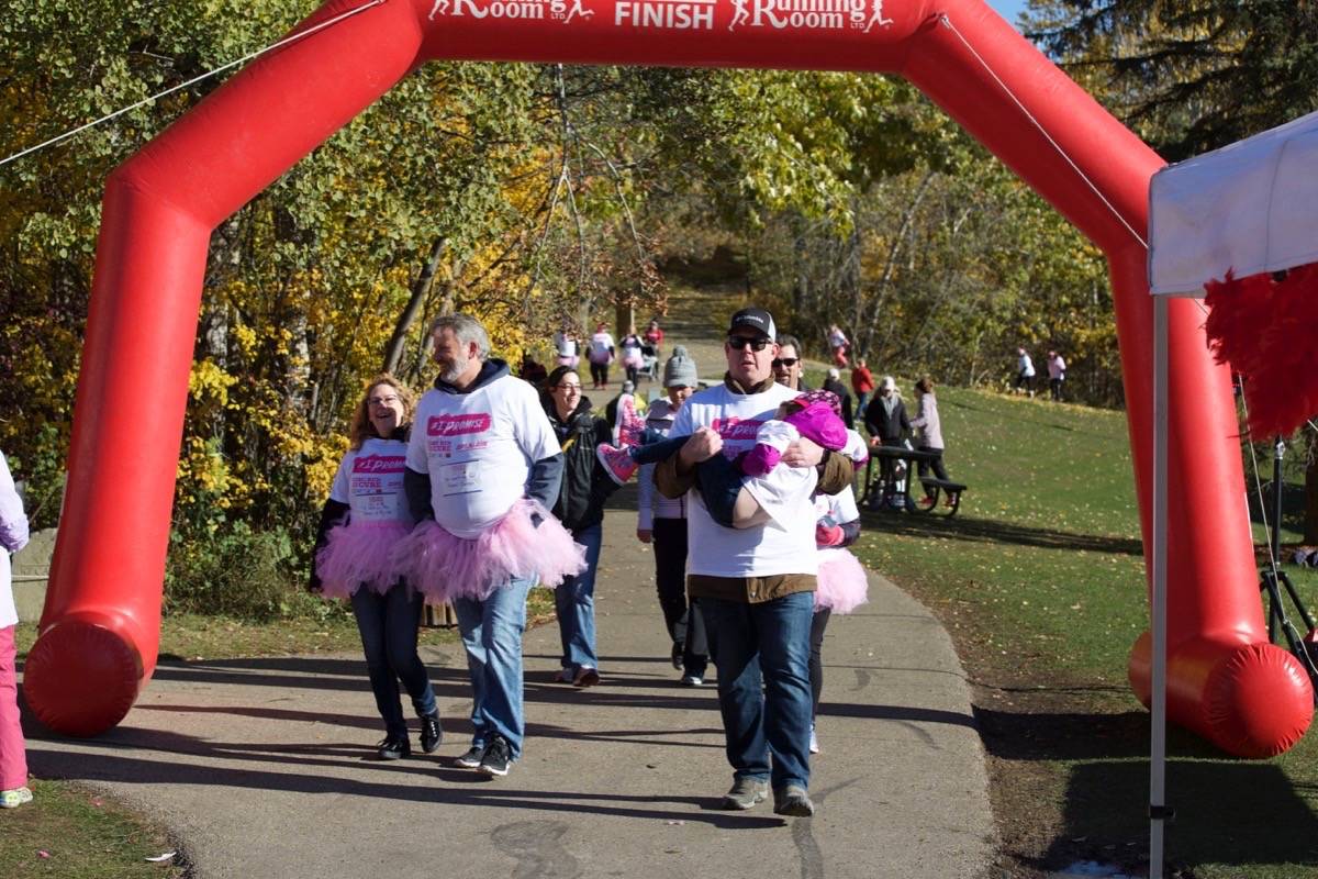 From left, Barb Oberst, Scott Carson and Scott MacMillian led a small group of walkers who came out for the CIBC Run for the Cure Sunday at Bower Ponds past the finish line. Robin Grant/Red Deer Express