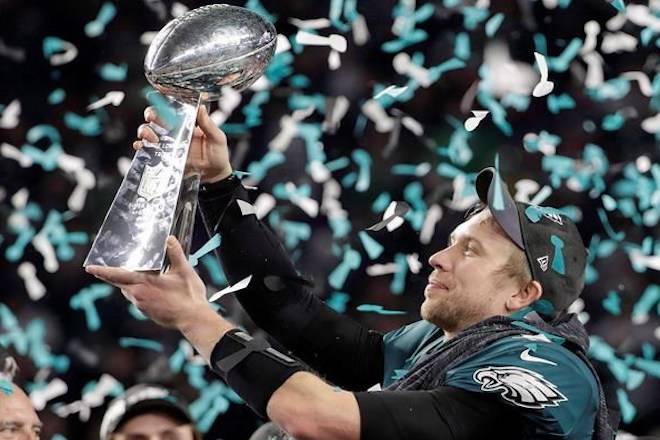 Philadelphia Eagles’ Nick Foles holds up the Vince Lombardi Trophy after the NFL Super Bowl 52 football game against the New England Patriots, Sunday, Feb. 4, 2018, in Minneapolis. Will Canadian fans of big-budget, American Super Bowl ads get to see them while the NFL championship game is played next February, or will that be ruled out of bounds after just two seasons? THE CANADIAN PRESS/AP/Chris O’Meara