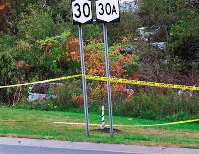 FILE - In this Oct. 6, 2018, file photo, a limousine, left, has landed in the woods following a fatal crash in Schoharie, N.Y. (Tom Heffernan Sr. via AP, File)