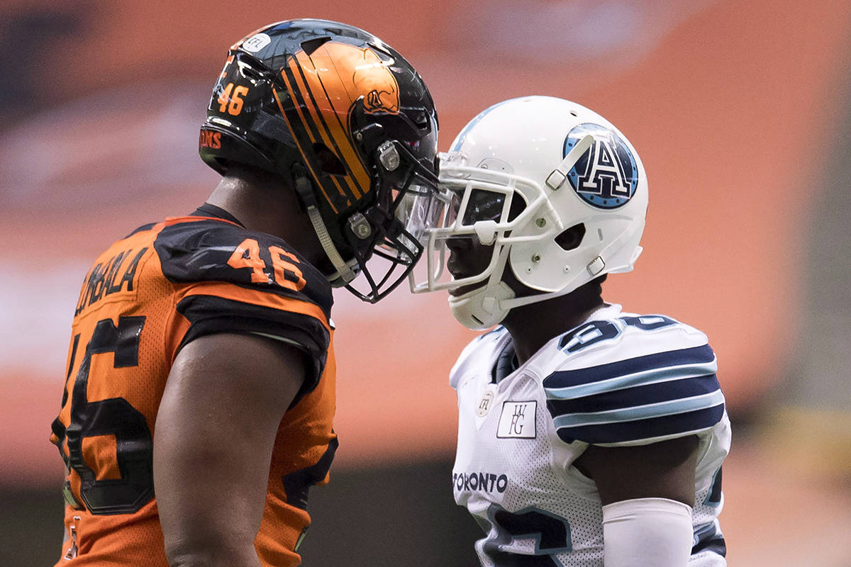 Toronto Argonauts defensive back Trumaine Washington (36) has words with BC Lions fullback Rolly Lumbala (46) during CFL football action in Vancouver on Saturday, Oct. 6, 2018. THE CANADIAN PRESS/Jonathan Hayward