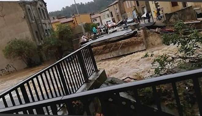 This photo provided by Stephane Jourdain, after a torrent of water ripped out the bridge in Villegailhenc, southern France, Monday Oct. 15, 2018. (AP Photo/Stephane Jourdain)