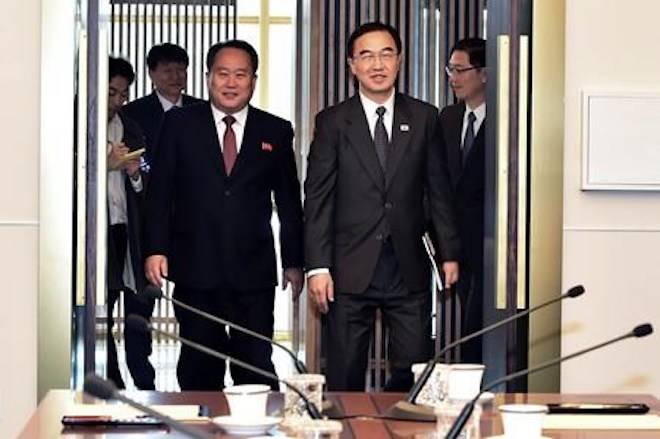 South Korean Unification Minister Cho Myoung-gyon, right, and his North Korean counterpart Ri Son Gwon arrive to hold their meeting at the southern side of Panmunjom in the Demilitarized Zone, South Korea, Monday, Oct. 15, 2018. (Korea Pool via AP)