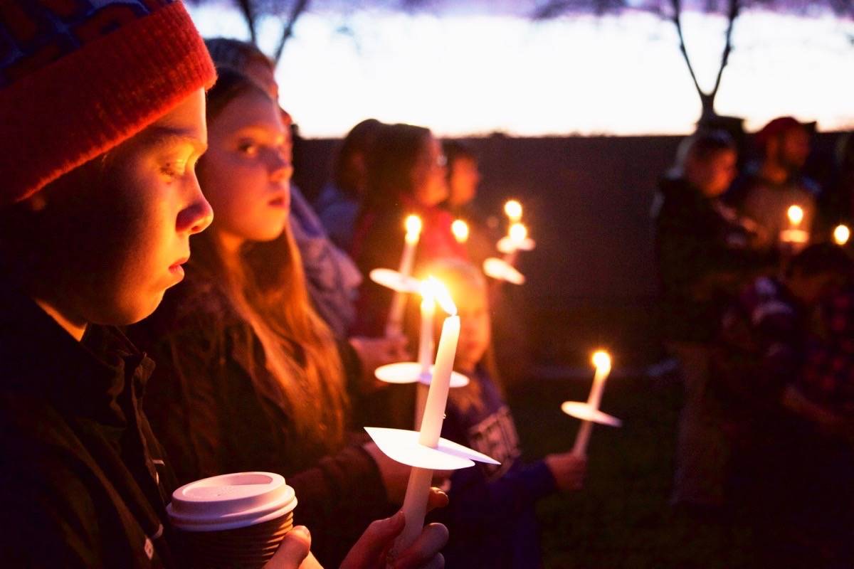Deric Abbott, 13, and his sister Arwynn, 12, hold candles during the Wave of Light ceremony on Monday at Westerner Park. The international event is part of Baby Loss Remembrance Day and supports parents whose infant or baby has died.                                Robin Grant/Red Deer Express