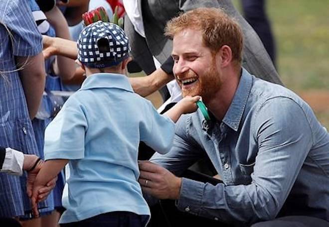 Britain’s Prince Harry is greeted by Luke Vincent, 5, on his arrival in Dubbo, Australia, Wednesday, Oct. 17, 2018. (Phil Noble/Pool via AP)