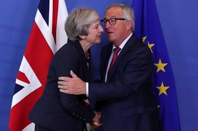 British Prime Minister Theresa May, left, hugs Jean-Claude Juncker, President of the European Commission, as they meet in Brussels, Wednesday, Oct. 17, 2018 when European leaders meet to negotiate on terms of Britain’s divorce from the European Union. (AP Photo/Francisco Seco)