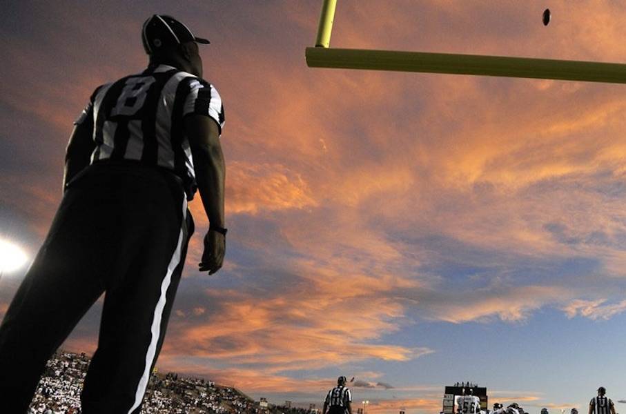 A referee watches the ball fly through the uprights. (Jack Dempsey/AP)