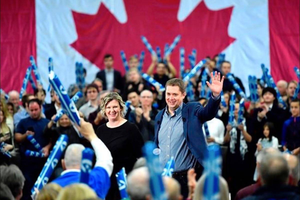Conservative leader Andrew Scheer waves to supporters as his wife Jill joins him on stage, following a pre-election event in Ottawa on Sunday, Oct. 21, 2018. (Justin Tang/The Canadian Press)