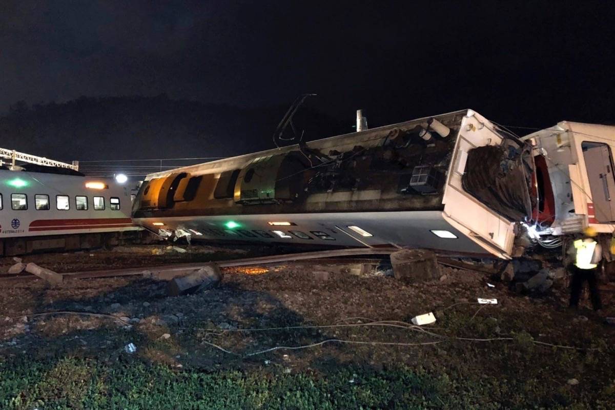 In this photo released by Taiwan Railways Administration, train carriages are scattered at the site of a train derailment in Lian in northern Taiwan on Sunday, Oct. 21, 2018. The Puyuma express train was carrying more than 300 passengers toward Taitung, a city on Taiwan’s southeast coast, when it went off the tracks on Sunday afternoon. (Taiwan Railways Administration via AP)