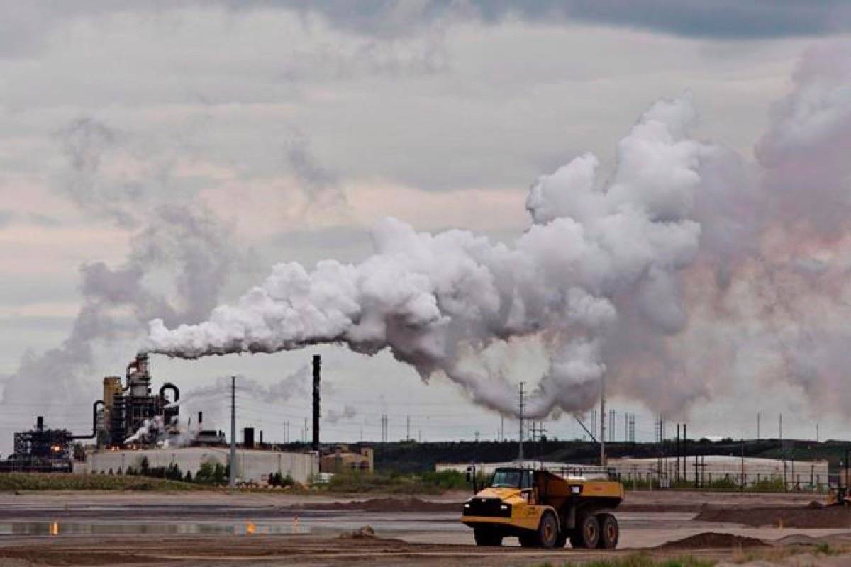 A dump truck works near the Syncrude oil sands extraction facility near the city of Fort McMurray, Alta., on June 1, 2014. Canadians will find out Tuesday exactly how they will be compensated for the upcoming federal carbon tax. The Canadian Press has learned Prime Minister Justin Trudeau will be in Toronto with Environment Minister Catherine McKenna to unveil the long-promised rebate plan, as well as which provinces will be subjected to the federally-imposed price on pollution. (Jason Franson/The Canadian Press)