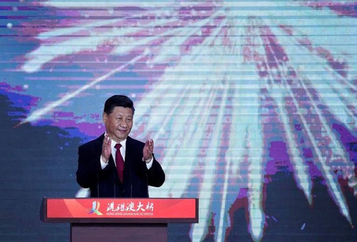 Chinese President Xi Jinping applauds on stage after official opening of the China-Zhuhai-Macau-Hong Kong Bridge, the world’s longest cross-sea project, which has a total length of 55 kilometers (34 miles), in Zhuhai in south China’s Guangdong province, Tuesday, Oct. 23, 2018. (AP Photo/Andy Wong)