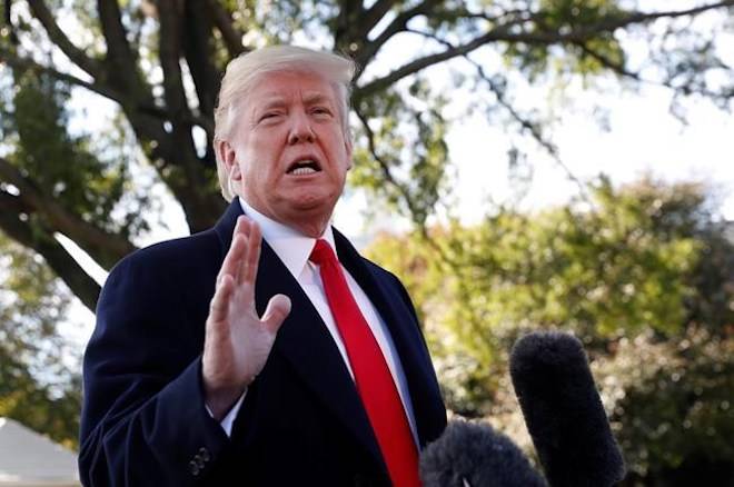 President Donald Trump stops to talk to members of the media before walking across the South Lawn of the White House in Washington, Monday, Oct. 22, 2018, to board Marine One helicopter for a short trip to Andrews Air Force Base, Md., en route to Houston. (AP Photo/Pablo Martinez Monsivais)