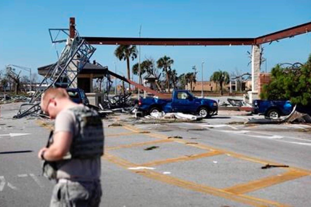 A soldier stands guard at the damaged entrance to Tyndall Air Force Base in the aftermath of hurricane Michael in Panama City, Fla., on October 11, 2018. (David Goldman/The Canadian Press/AP)