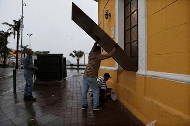 Workers board up windows prior the landfall of Hurricane Willa, in Mazatlan, Mexico, Tuesday, Oct. 23, 2018. (AP Photo/Marco Ugarte)