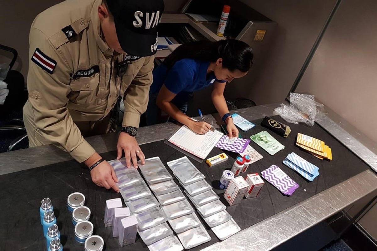 Interpol staff sort through illicit drugs seized as part of Operation Pangea. (Interpol)