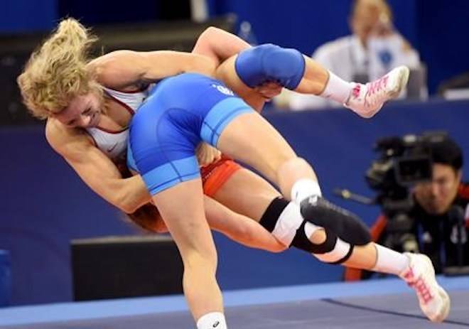Oksana Livach, in blue, of Ukraine wins against Jessica Anne Marie MacDonald of Canada in the qualification of the women’s 50kg category of the Wrestling World Championships in Budapest, Hungary, Wednesday, Oct. 24, 2018. (Balazs Czagany/MTI via AP)