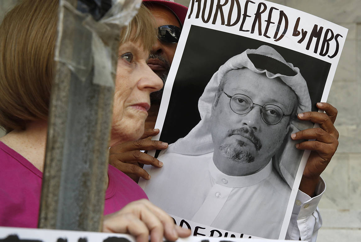 In this Oct. 10, 2018, file photo, people hold signs during a protest at the Embassy of Saudi Arabia about the disappearance of Saudi journalist Jamal Khashoggi, in Washington. Saudi Arabia’s financial clout among the Arab media has given it an influential tool as it grapples with the international outcry first over the disappearance and later the death of Saudi writer Jamal Khashoggi. (Jacquelyn Martin/AP Photo)