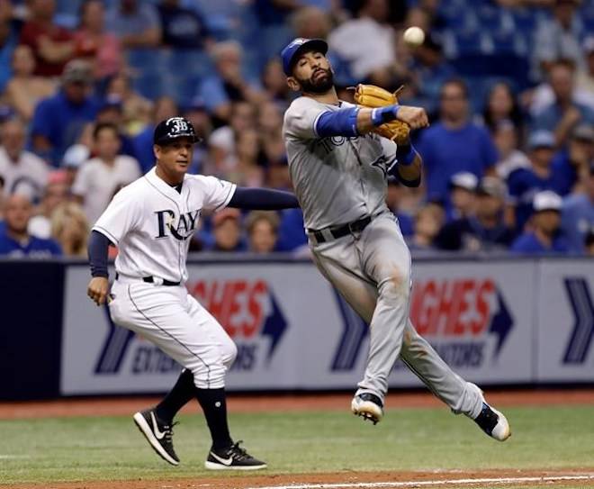 Toronto Blue Jays third baseman Jose Bautista leaves his feet but can’t throw out Tampa Bay Rays’ Wilson Ramos at first on an RBI single as Rays third base coach Charlie Montoyo looks on during the fifth inning of a baseball game in St. Petersburg, Fla., on August 22, 2017. THE CANADIAN PRESS/AP, Chris O’Meara