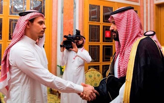 In this photo released by Saudi Press Agency, SPA, Saudi Crown Prince Mohammed bin Salman, right, shakes hands with Salah Khashoggi, a son, of Jamal Khashoggi, in Riyadh, Saudi Arabia, Tuesday, Oct. 23, 2018. (Saudi Press Agency via AP)