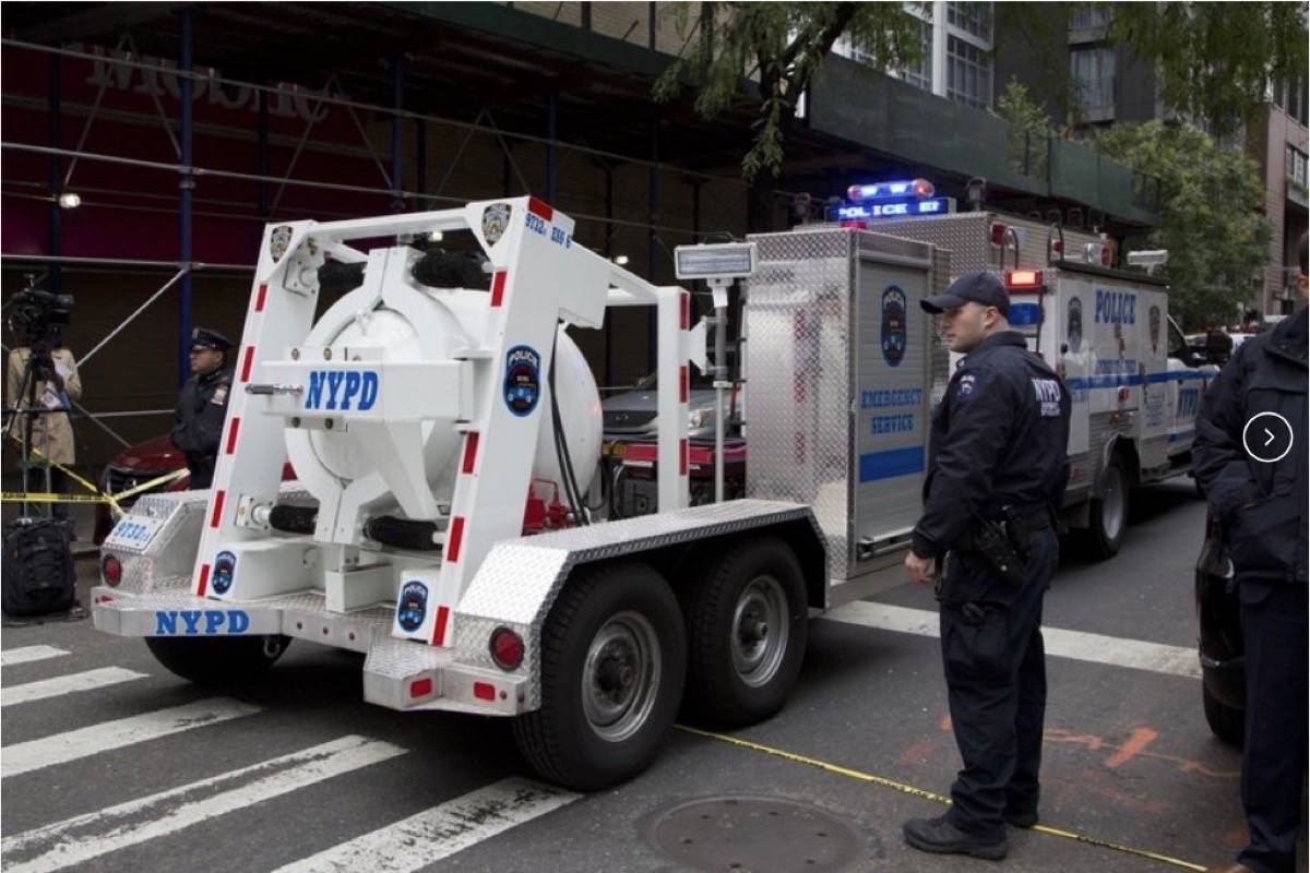 A police truck tows a containment vessel to a post office in Manhattan to dispose of a suspicious package on Friday, Oct. 26, 2018, in New York. (Associated Press)